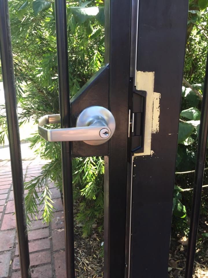 Lever handle and deadbolt fitted to a black entry door